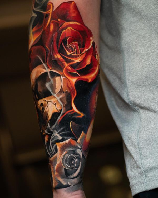 Flaming roses and skull tattoo forearm