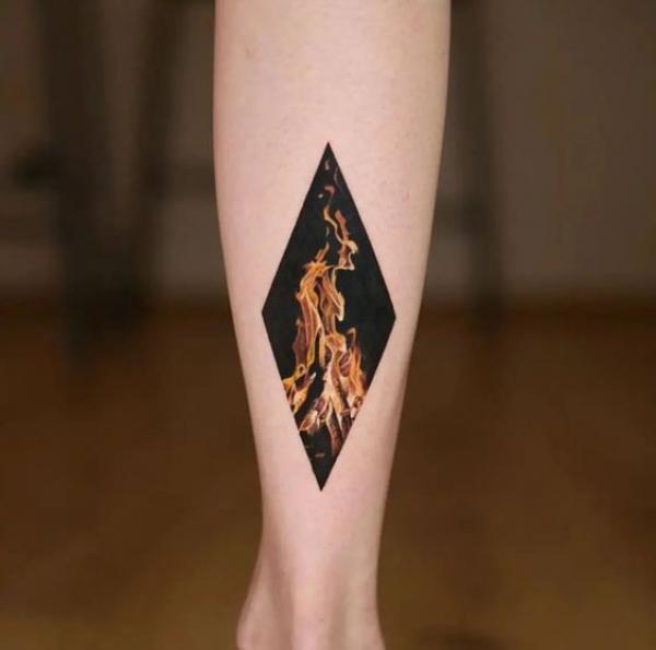 Geometric fire tattoo on lower leg