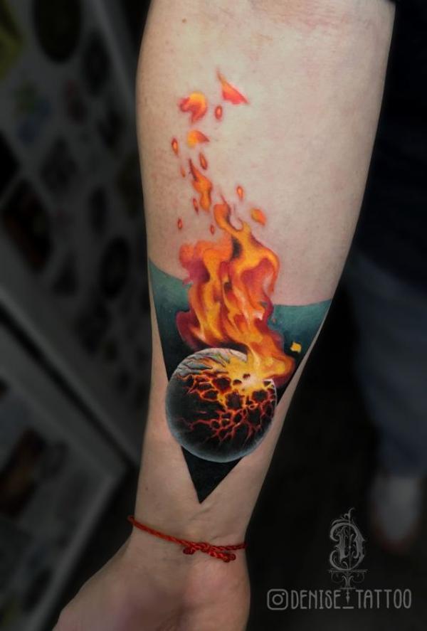 Global in fire tattoo on forearm
