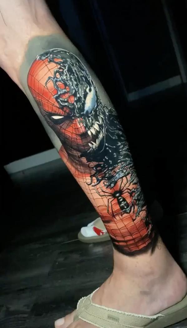 Half red half dark spider man tattoo on lower leg