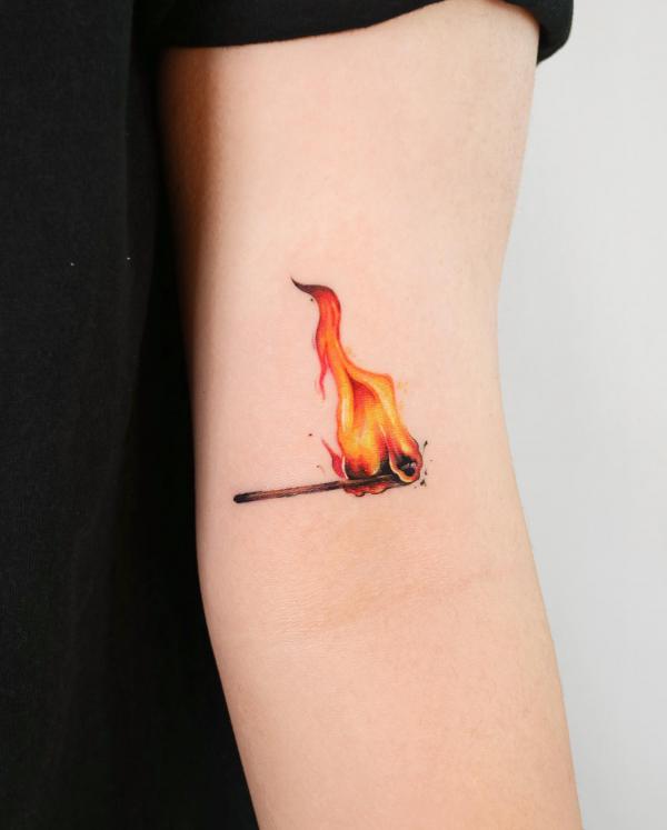 Match lit fire inner elbow tattoo