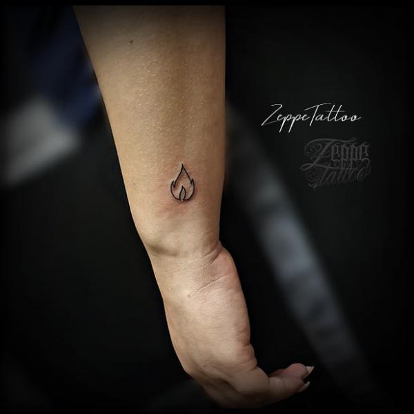 Minimalist fire wrist tattoo