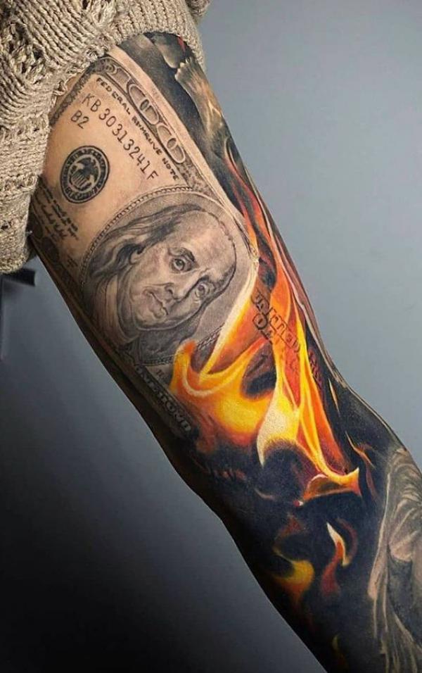 Money in flame tattoo on arm