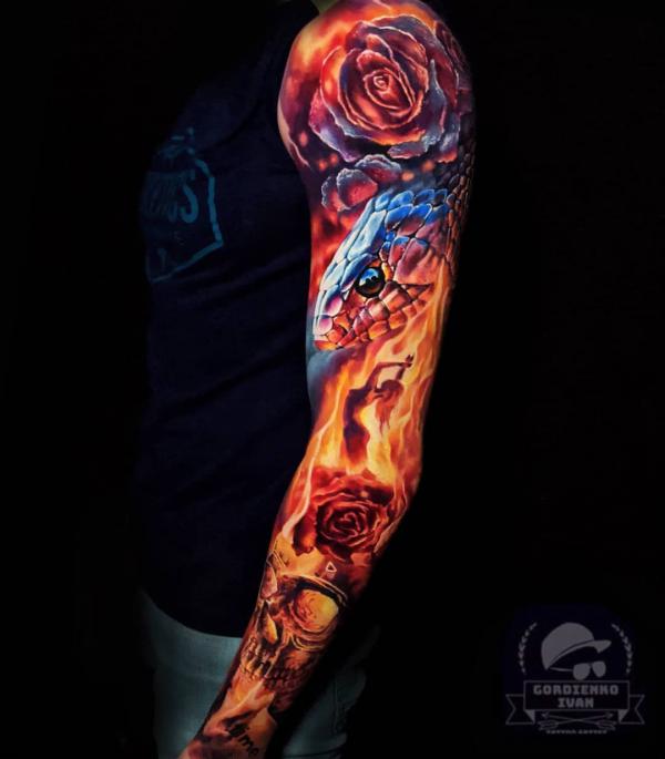 Realistic snake and rose in fire tattoo sleeve