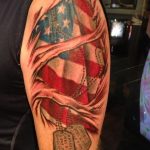 Ripped skin American flag with dog tag tattoo half sleeve