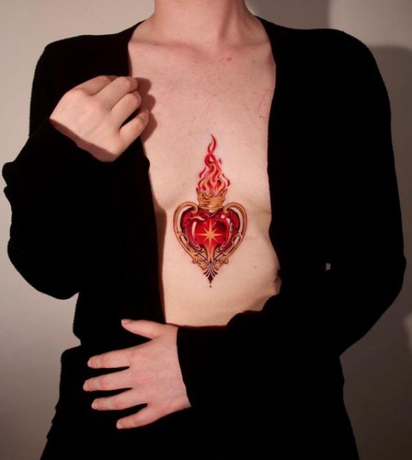 Sacred heart with flame sternum tattoo