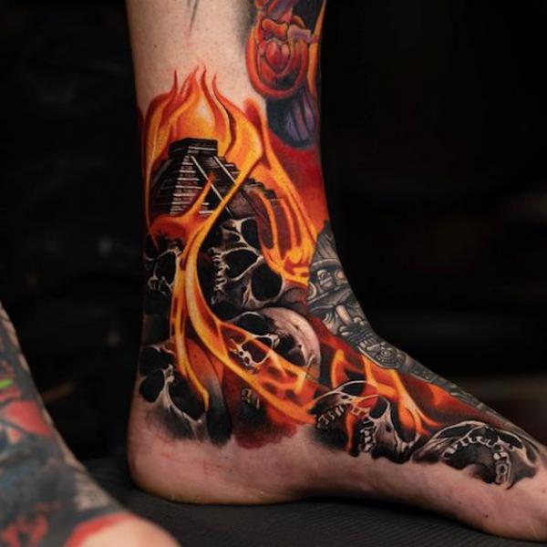 Skulls and Pyramid in flame foot tattoo