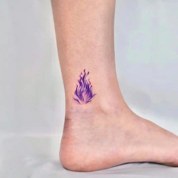 Small flame ankle tattoo in purple color