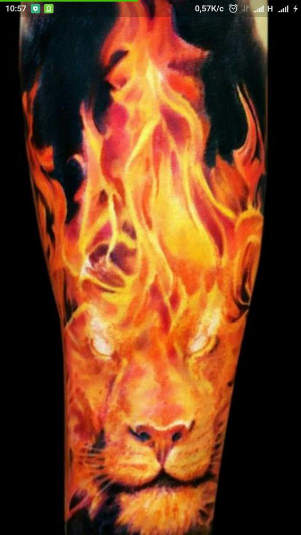 Tiger in fire tattoo on forearm