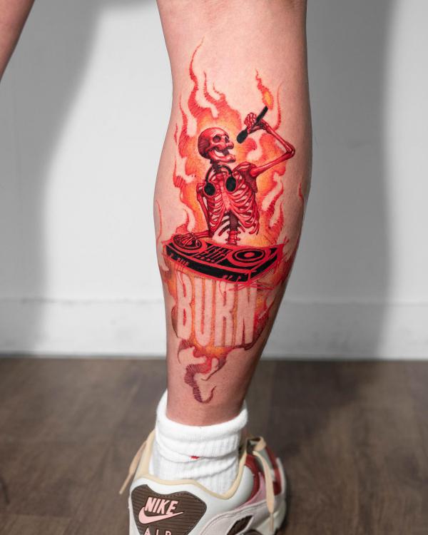 burning skeleton tattoo on calf