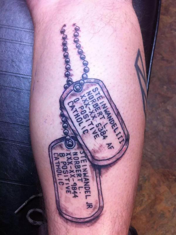 dog tag tattoo on inner forearm