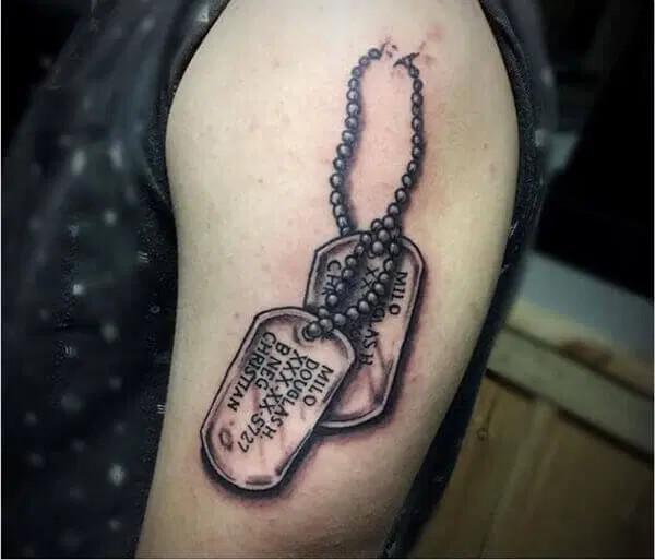 dog tag tattoo on upper arm