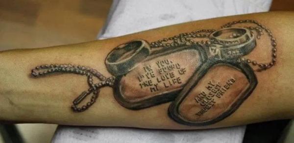 dog tag with ring tattoo forearm