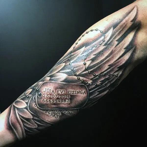dog tag with wing tattoo forearm