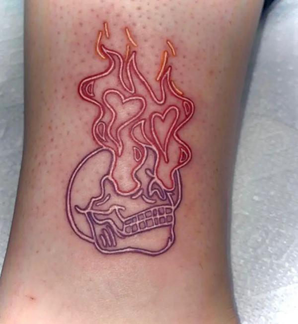 fire and skull line work tattoo