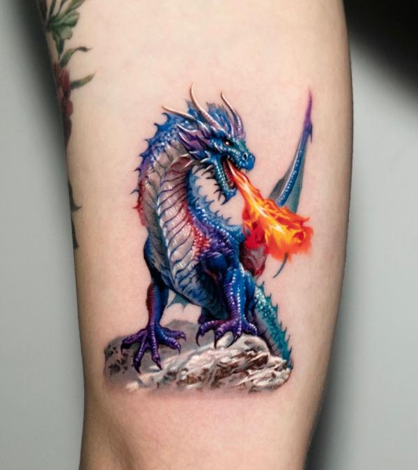 fire breathing dragon tattoo on arm