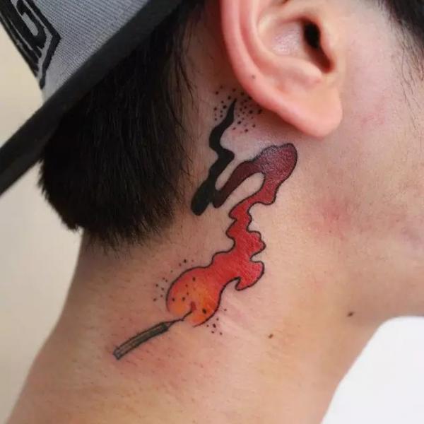 flame tattoo behind the ear