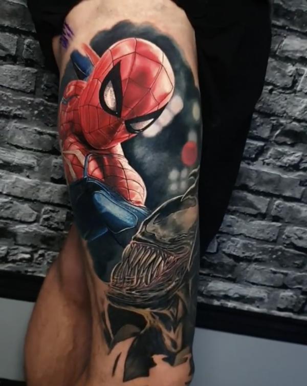 spider man and venom tattoo on side thigh