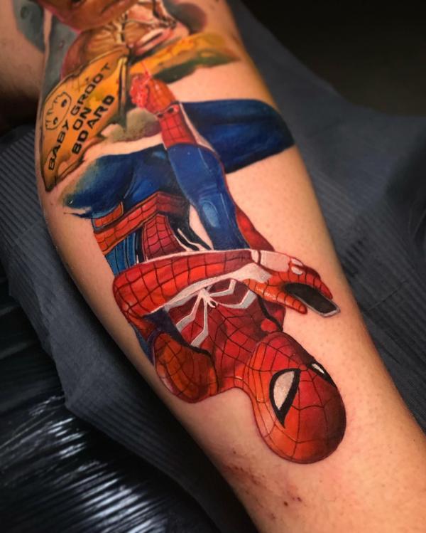 upside down spider man tattoo on leg