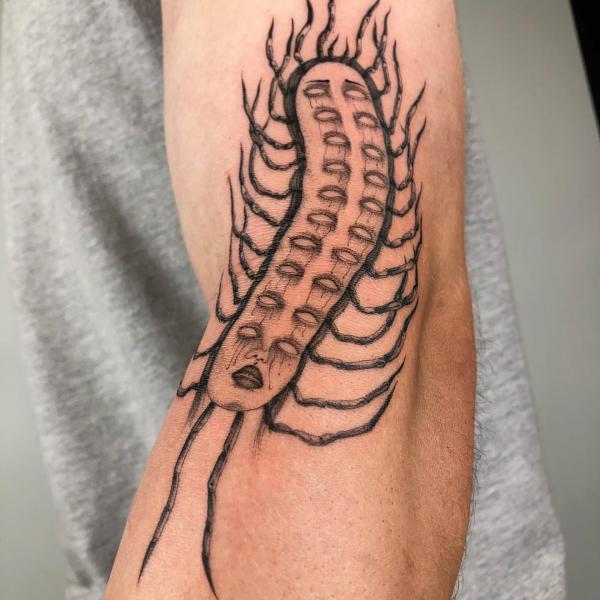 Abstract centipede tattoo on arm