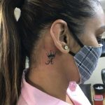 Ace of spade with crown tattoo behind ear