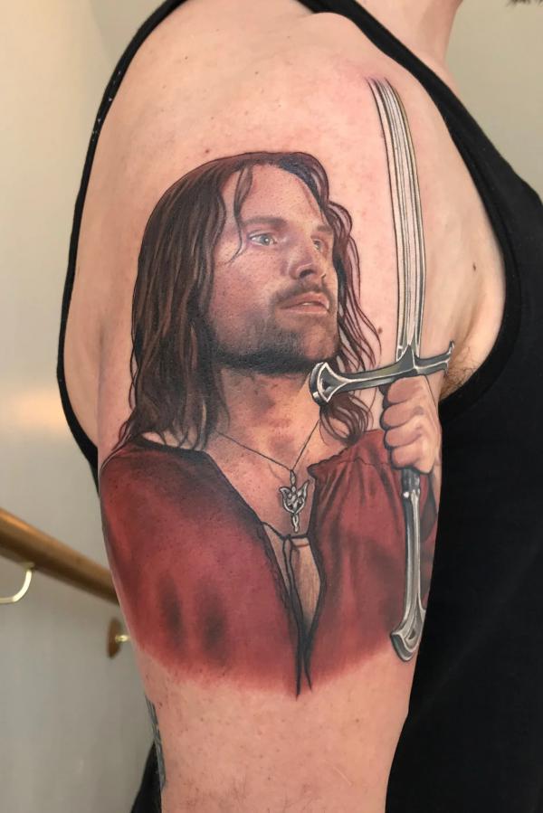 Aragorn holding a sword tattoo