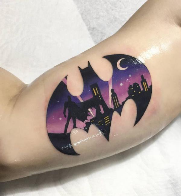 Batman logo tattoo on bicep
