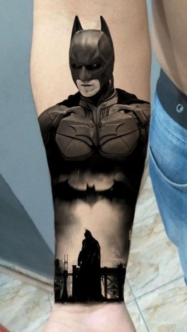 Black Batman with bat tattoo on inner forearm
