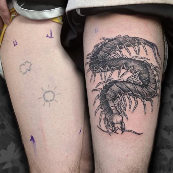 Black and grey centipede tattoo thigh