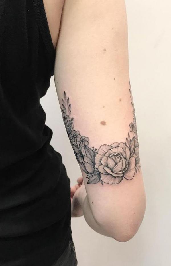 Black and grey peony tricep tattoo