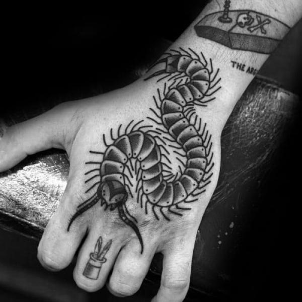 Black and white traditional centipede hand tattoo