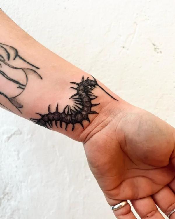 Centipede wrist tattoo blackwork