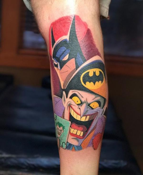 Colored Batman and joker tattoo arm