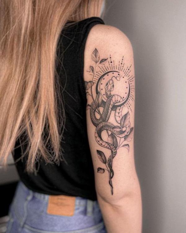 Crescent moon and snake tricep tattoo