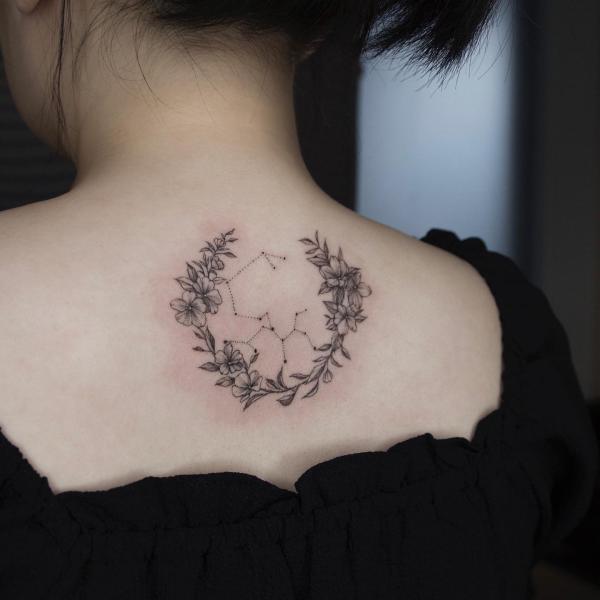 Floral wreath and Sagittarius constellation tattoo