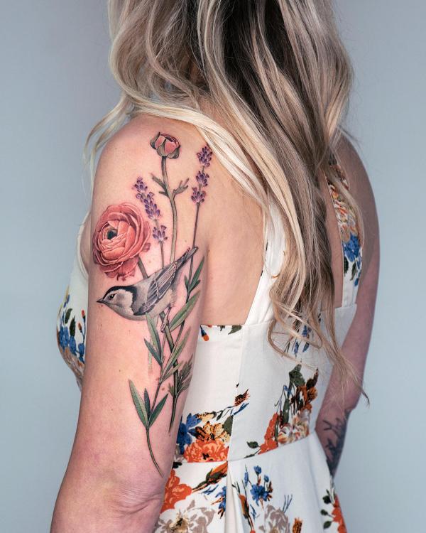Flower and bird tricep tattoo