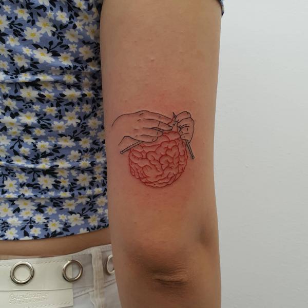 Hands and brain tricep tattoo
