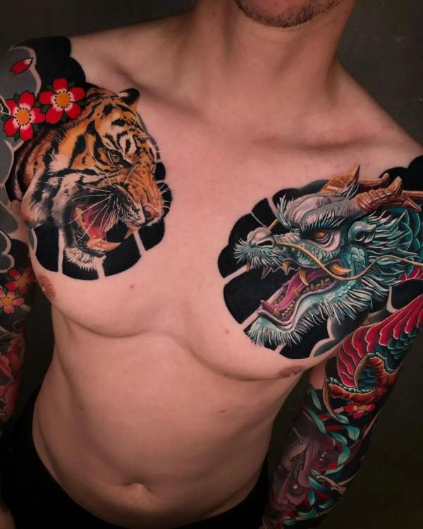 Japanese tiger and dragon heads chest panel tattoo