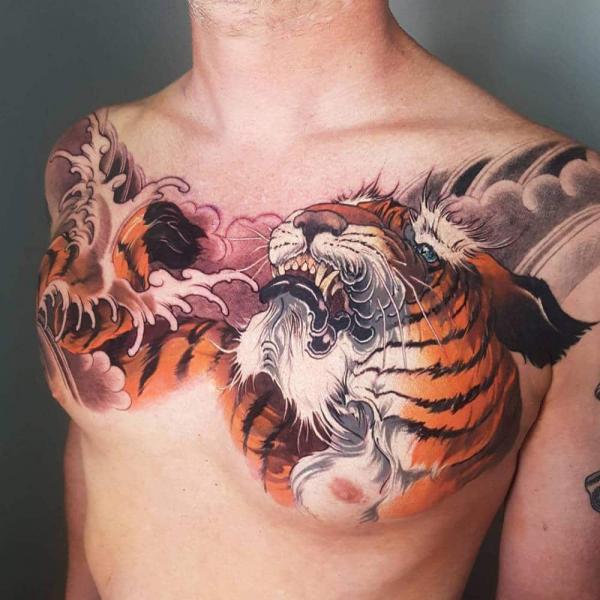 Japanese wave and tiger head chest panel tattoo