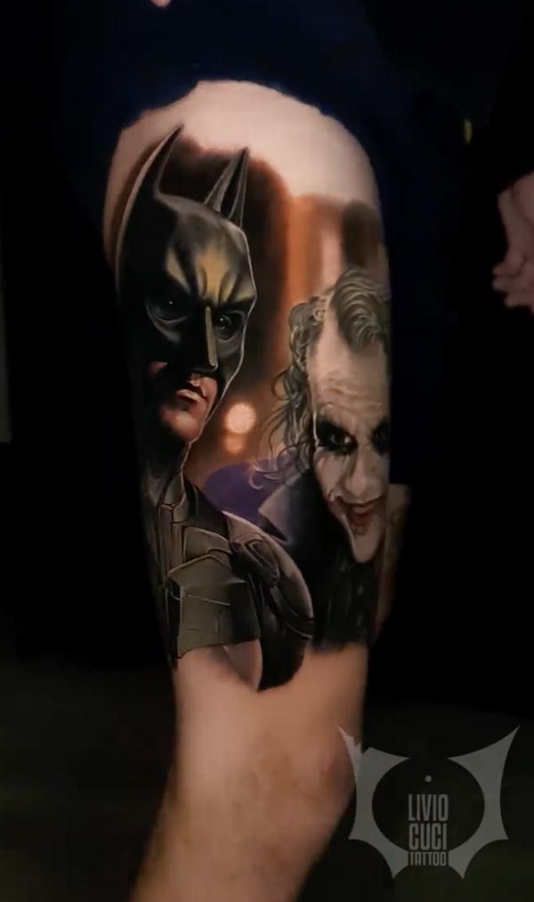 Joker and batman tattoo on upper arm