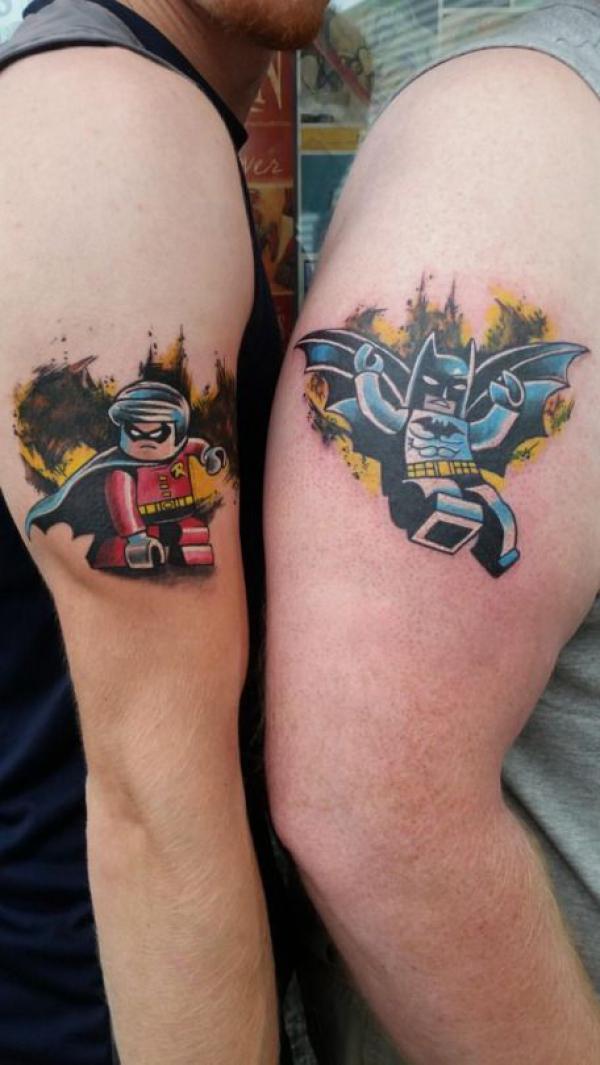 Lego and batman tattoo above knees