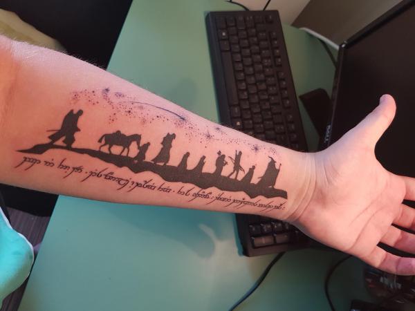 Lord of the rings tattoo with quote on forearm