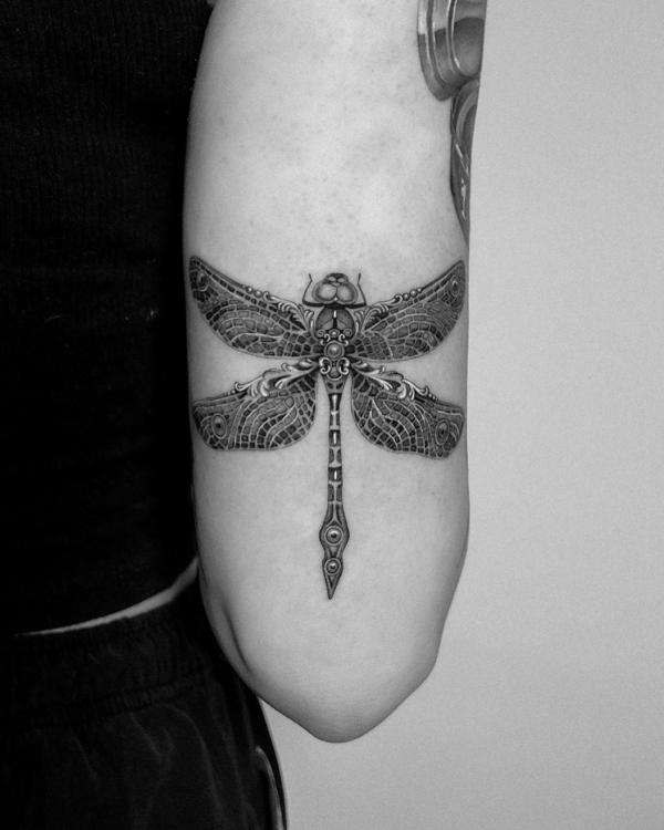 Metallic dragonfly tricep tattoo