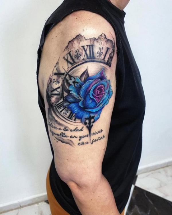 Partial clock and blue rose tattoo