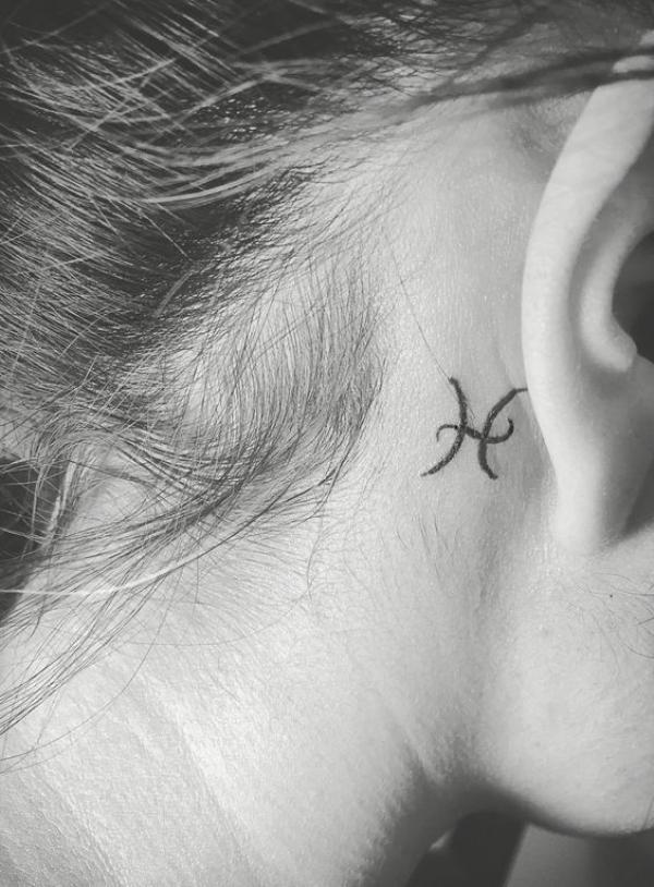 Pisces glyph tattoo behind the ear