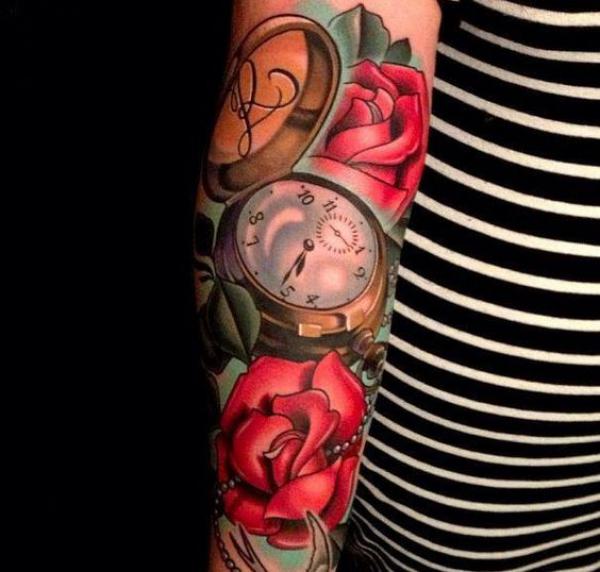 Red roses and pocket watch tattoo arm