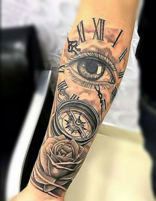Rose and clock with eye tattoo forearm