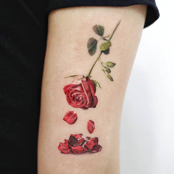 Rose and petals tricep tattoo
