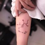 Sagittarius floral constellation forearm tattoo