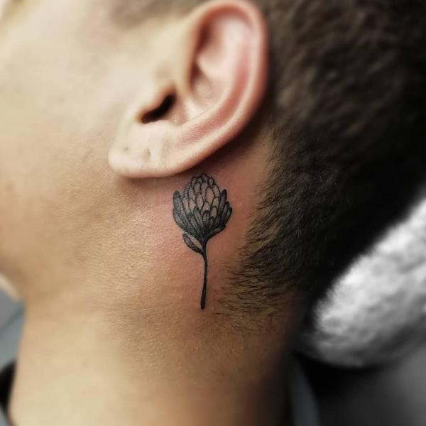 Small protea tattoo behind ear